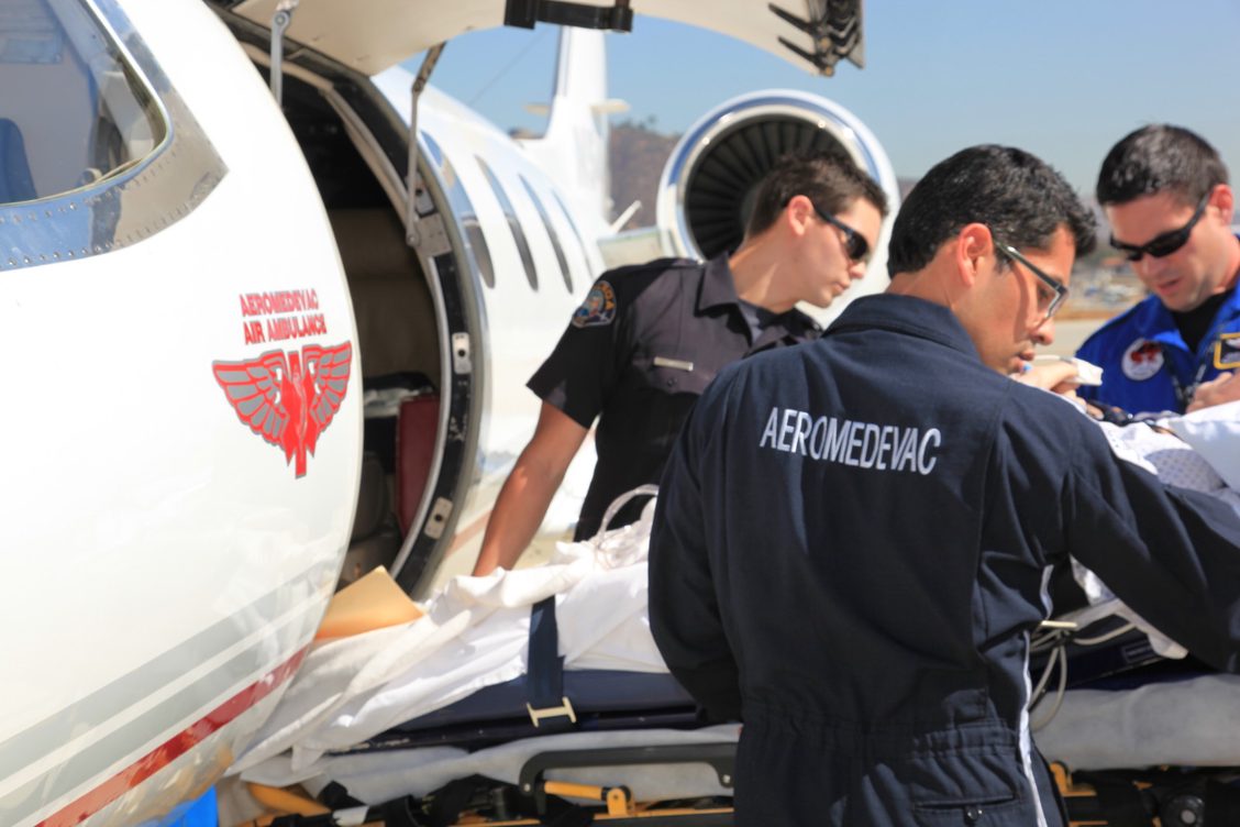 Air Ambulance Professionals preparing a medical patient for a flight