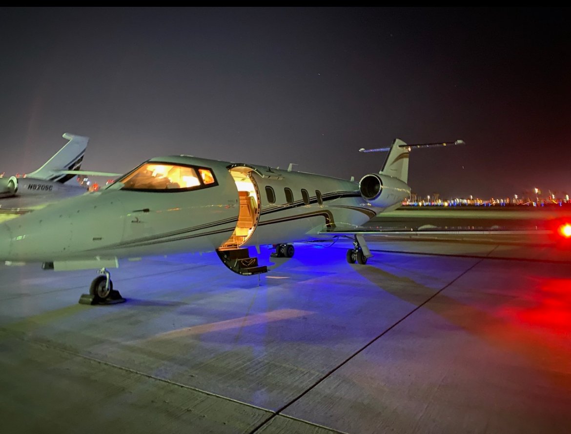 Aeromedevac airplane at patient destination with glowing lights from plane