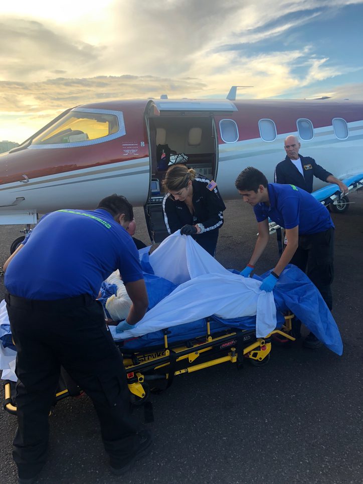 Aeromedevac medical and flight teams working with ground ambulance teams to transfer a patient after another successful flight