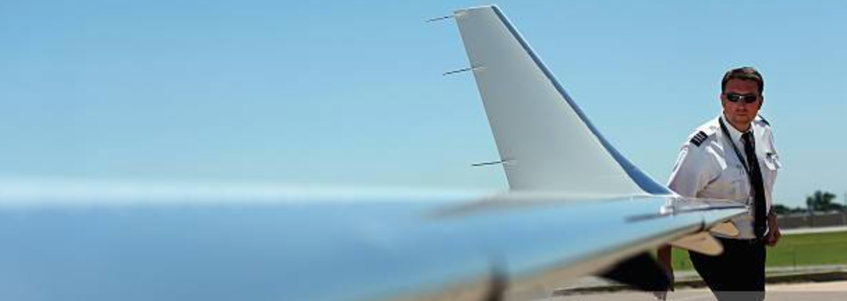 The pilot is inspecting an Aeromedevac Air Ambulance read jet 45 wing tip.